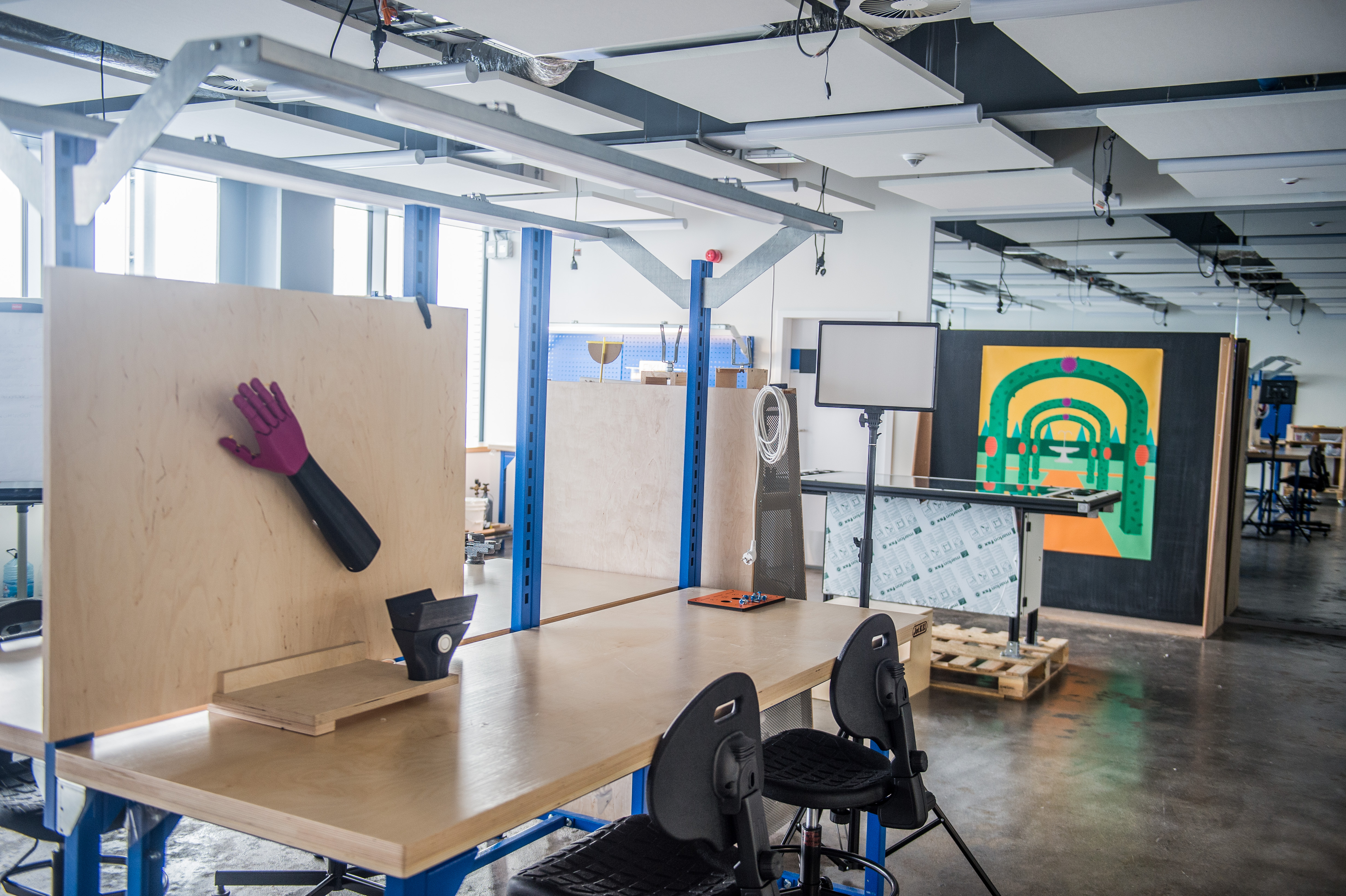 Prototypownia w Pracowni Przewrotu Kopernikańskiego - duże jasne pomieszczenie ze stołami warsztatowymi, półkami z narzędziami i stanowiskami do pracy.
